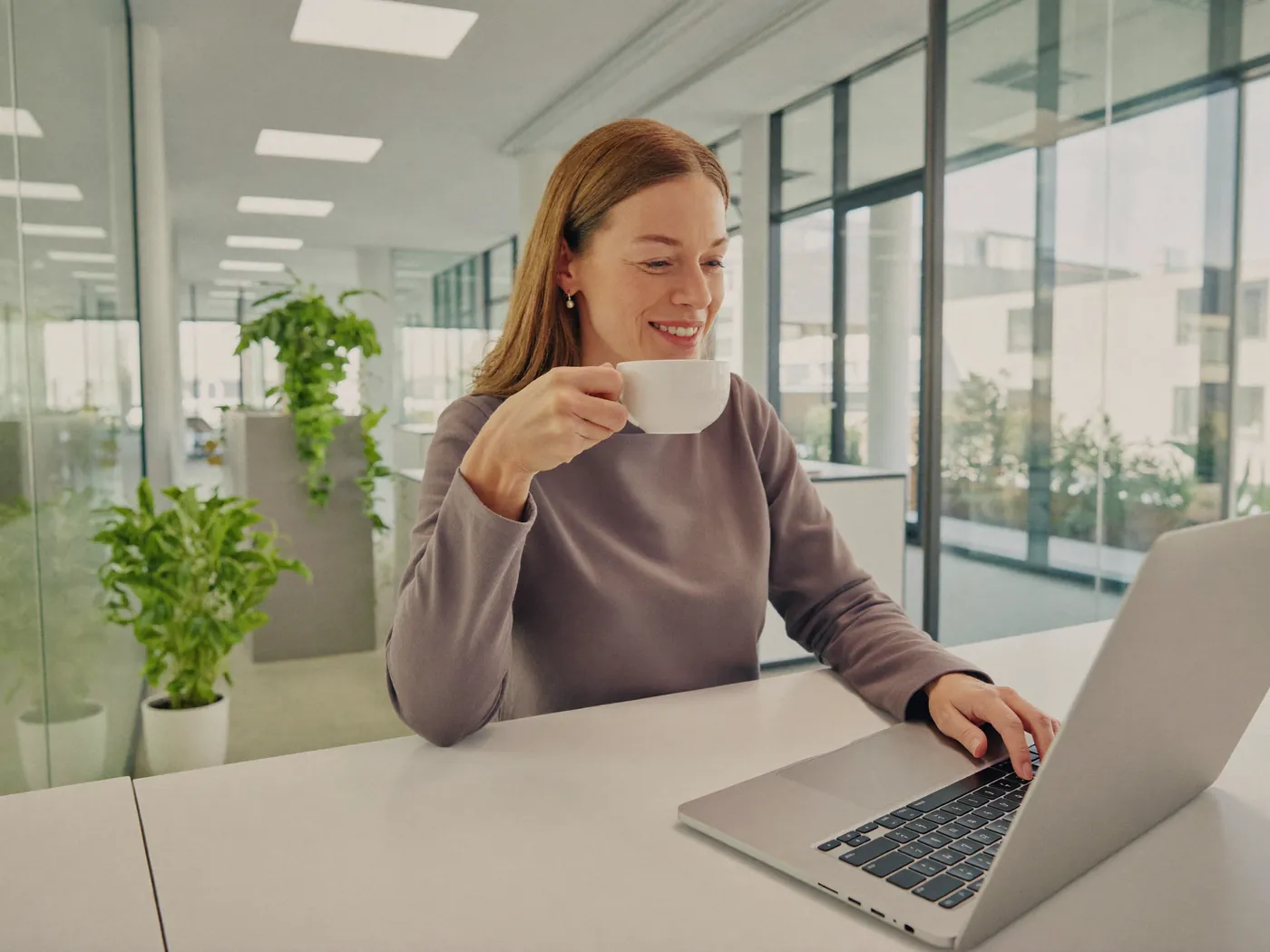 HR-Managerin freut sich am Laptop über neue, passende Bewerbungen